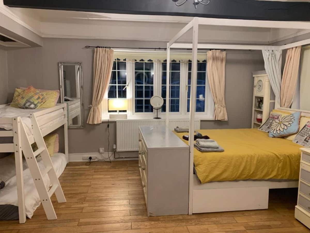 A family room at Halzephron House with bunk beds and a double bed