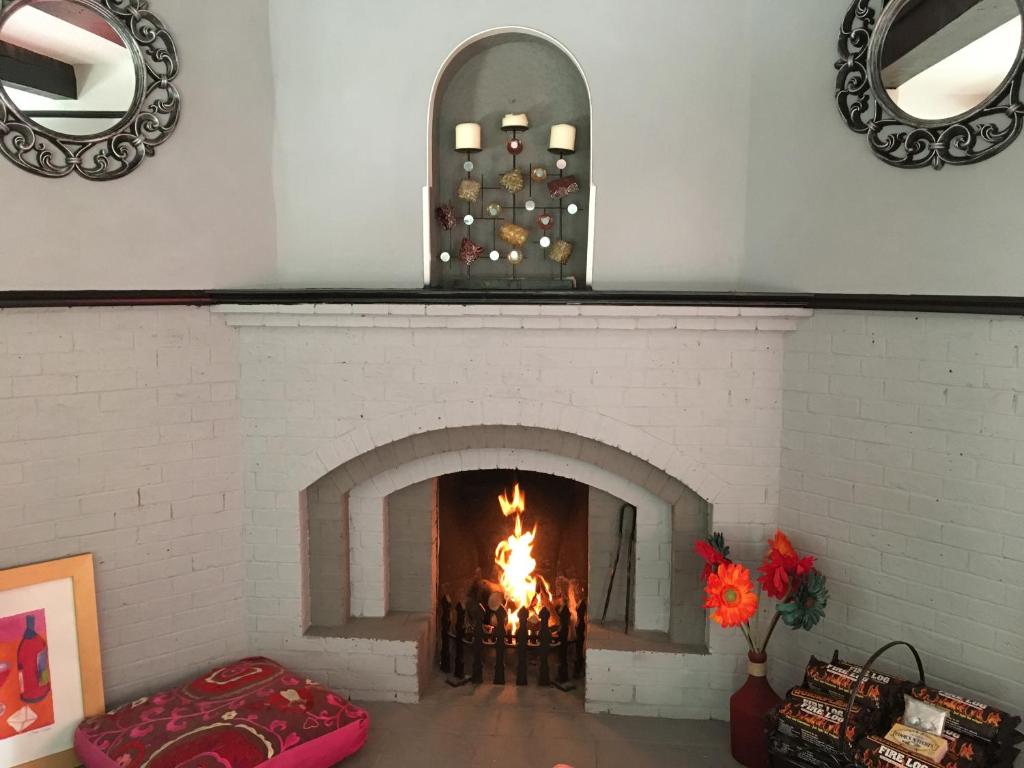 A fire lit in Halzephron House's arched fireplace