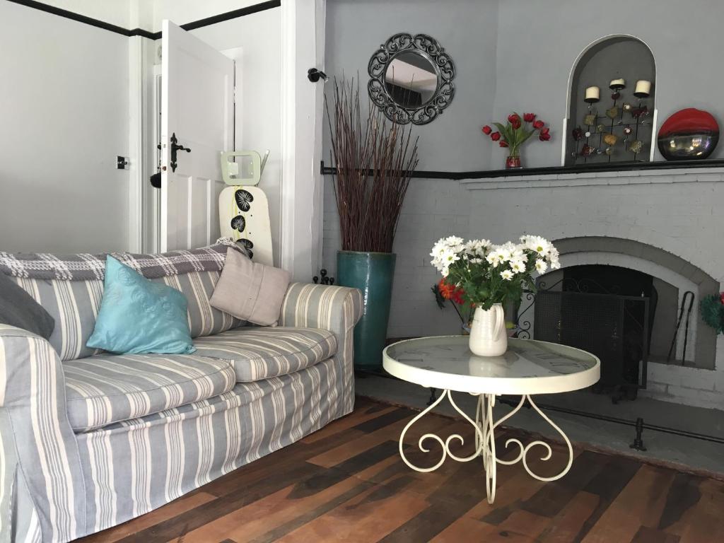 Halzephron House sitting room with striped sofa and fireplace